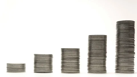 Silver coins on stacks are decrease and increase on white background stop motion 库存影片 128310894