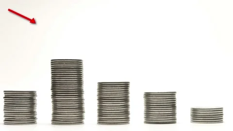 Silver coins on stacks are decrease with red arrow on white background stop Stockbeeldmateriaal 142708330