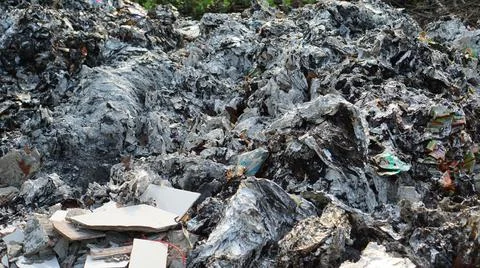 Silver colored burnt trash. Plastic Garbage. Plastic Waste. Foto stock