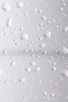Silver colored metal surface covered with drops of pure water, wet silver-col Stock Photos