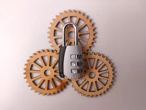 A silver combination padlock is positioned on top of three interconnected w.. Stock Photos