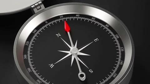 Silver compass needle moving across black dial during navigation task. 스톡 동영상 336333664