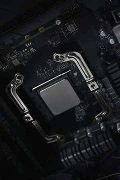Silver computer processor on a black motherboard 写真素材