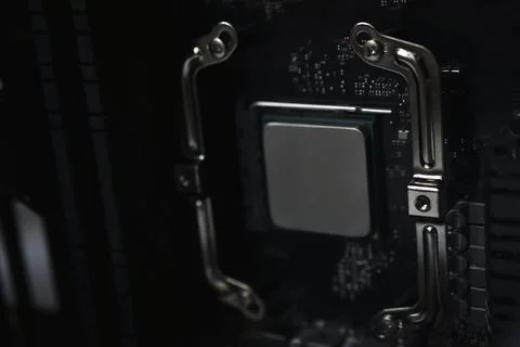 Silver computer processor on a black motherboard 写真素材