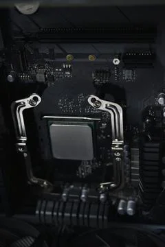 Silver computer processor on a black motherboard Stock Photos