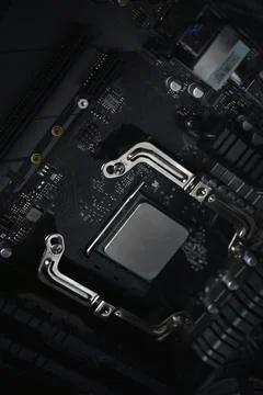 Silver computer processor on a black motherboard 스톡 사진