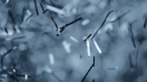 Silver confetti particles burst in slow motion, flying in the air Video stock 293102172