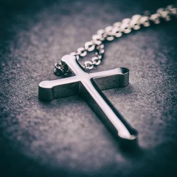 Silver cross on a gray background Stock Photos