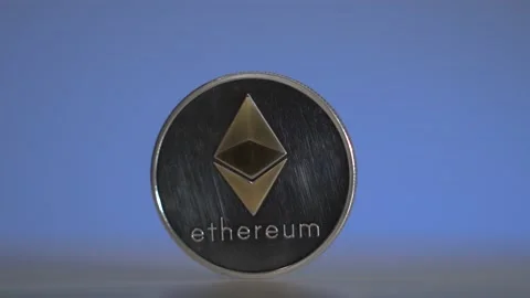 Silver cryptocoin with gold logo rotate on the white furface with blue Stock Footage 132318726