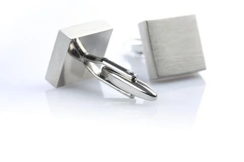 Silver cuff links on white background Stock Photos