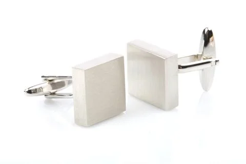 Silver cuff links on white background Stock Photos