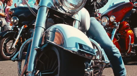 Silver custom bike makes a turn to the right on the highway to escape the parade Stock Footage 68631184