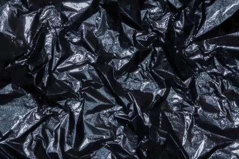 Silver dark shiny texture of a crumpled sheet. Stock Photos