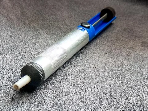 Silver desoldering pump tool showing functional design and utility, with bl.. Stock Photos