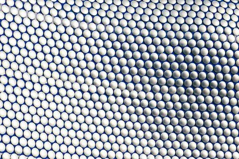 Silver Discs on Blue Surface:  Repeating Geometric Pattern Stock Photos