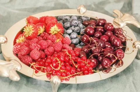 Silver dish with berries Stock Photos