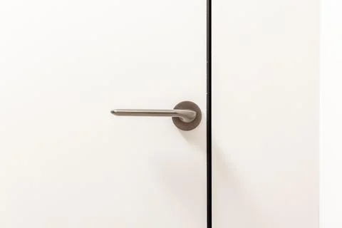 A silver door handle is shown in a mirror Photos