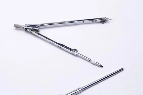 Silver Drawing Compass with Needle and Pencil Attachment on White Backgroun.. Stock Photos