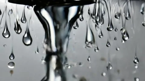Silver droplets falling gracefully on a silver background Stock Footage 312732765
