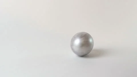 Silver egg spinning on a white background Video stock 126805220