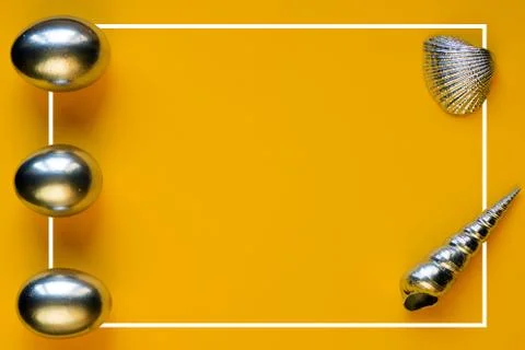 Silver eggs and shells on colored background Photos