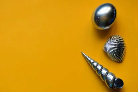 Silver eggs and shells on colored background 写真素材