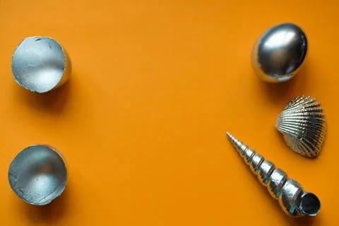 Silver eggs and shells on colored background Foto stock