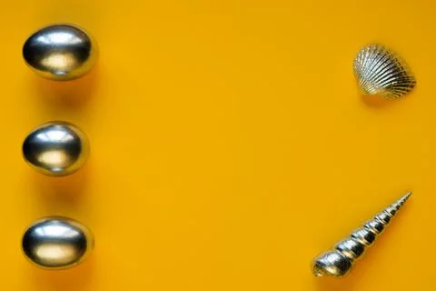 Silver eggs and shells on colored background Photos