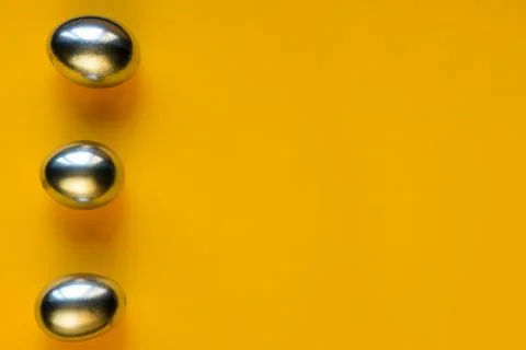 Silver eggs and shells on colored background Foto stock