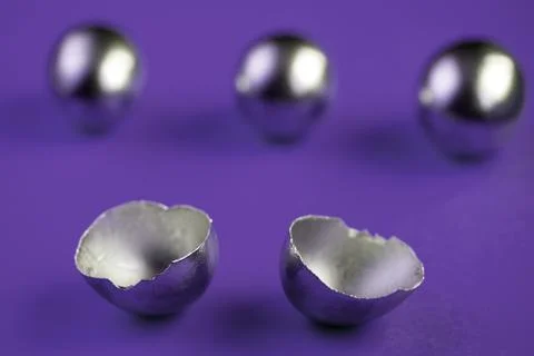 Silver eggs and shells on colored background Foto stock