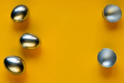 Silver eggs and shells on colored background Foto stock