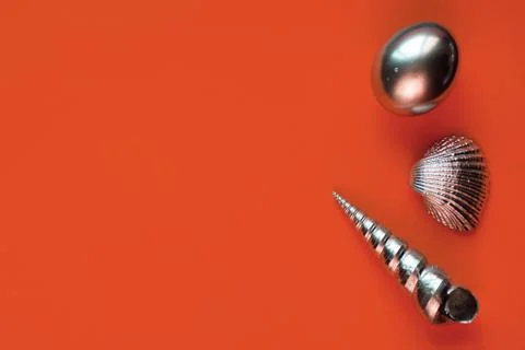 Silver eggs and shells on colored background Stock Photos