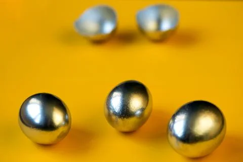 Silver eggs and shells on colored background 写真素材