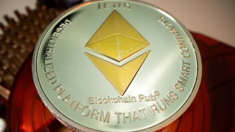 Silver Etherium ETH. Crupto currency. Close up shot. Top view. Red graphic card Stock Photos