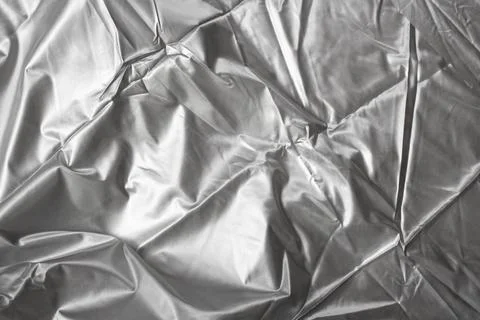 Silver fabric structure, crumpled texture, metallic abstract backdrop Stock Photos