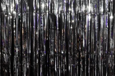 Silver festive background illuminated by colored lanterns. Stock Photos