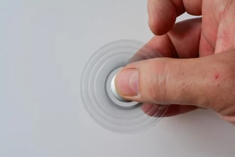 Silver fidget spinner in motion Stock Photos