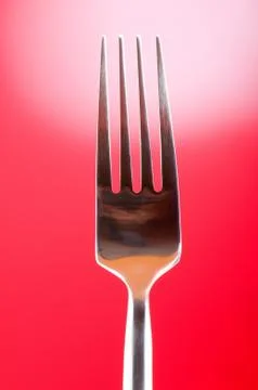 Silver fork against gradient color background Stock Photos