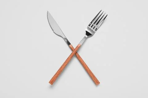 Silver fork and knife on grey background Stock Photos