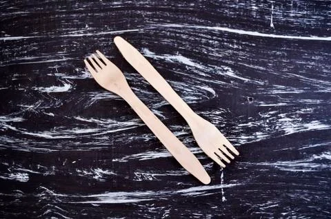 Silver fork lying on a wooden table. Cutlery for eating. Device Stock Photos