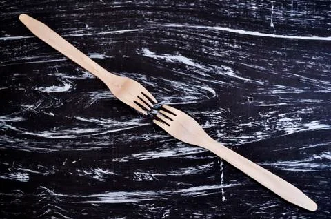 Silver fork lying on a wooden table. Cutlery for eating. Device Stock Photos