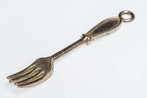 Silver fork-shaped pendant Stock Photos