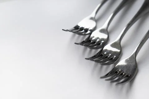 A silver forks on a white surface Stock Photos