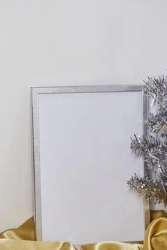 Silver frame mockup and silver Christmas tree close up. Place for text or Foto stock
