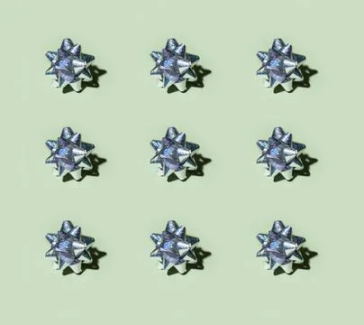 Silver gift bow pattern on basil green background Stock Photos