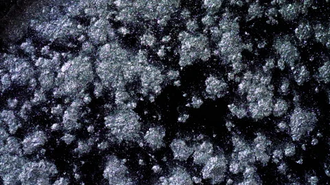 Silver glitter sparkle texture against black background in 4K Stock Footage 139014930