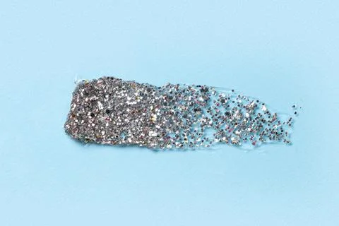 Silver glitter stroke on blue background Stock Photos