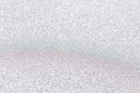 Silver glitter texture background. Defocused festive backdrop. Stock Photos
