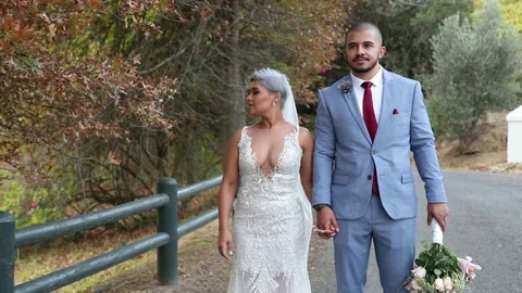 Silver Haired Bride And Her Groom Standing Hand In Hand Stock-Footage 118814433