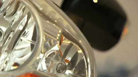 A silver headlight of a car shimmering in the light. Close Up. Stock Footage 35738764